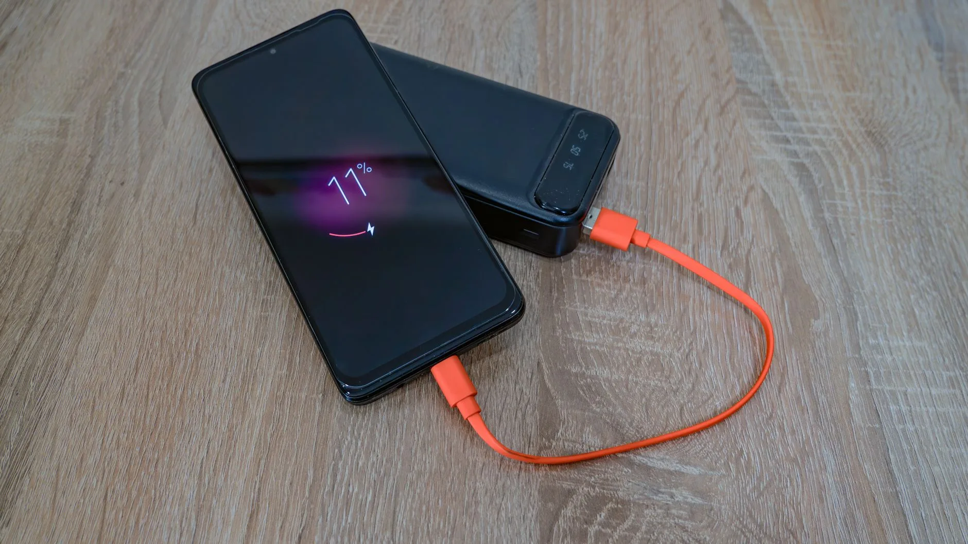A smartphone charging alongside a power bank