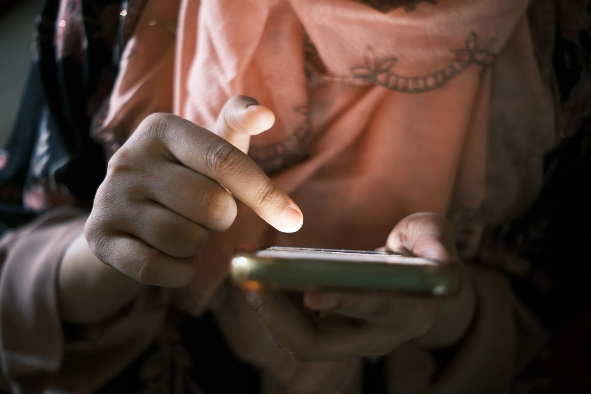 A hand scrolling on a smartphone screen