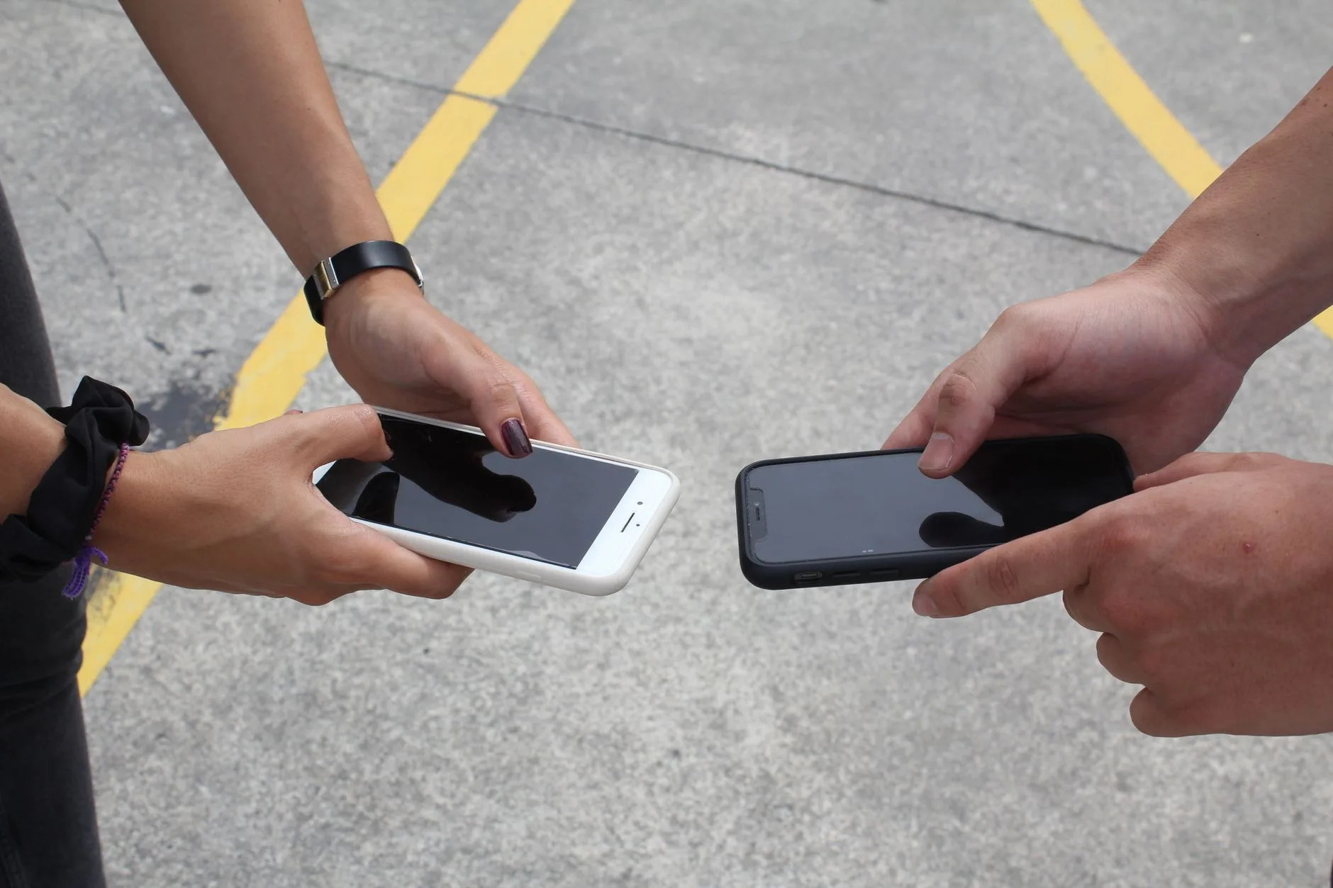 A person comparing two smartphones
